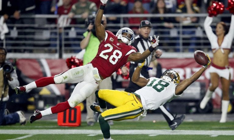 Green Bay Packers wide receiver Randall Cobb (18) makes a one-handed catch but has it called back on a penalty as Arizona Cardinals cornerback Justin Bethel (28) defends during the first half of an NFL divisional playoff football game, Saturday, Jan. 16, 2016, in Glendale, Ariz. (AP Photo/Rick Scuteri)  ORG XMIT: AZMY