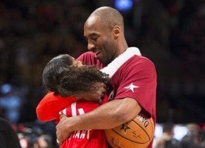 Los Angeles Lakers' Kobe Bryant (24) kisses his daughter before the first half of the NBA all-star basketball game, Sunday, Feb. 14, 2016 in Toronto. (Mark Blinch/The Canadian Press via AP)