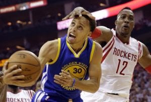 Houston Rockets center Dwight Howard (12) fouls Golden State Warriors guard Stephen Curry (30) during the first half in Game 3 of the NBA basketball Western Conference finals Saturday, May 23, 2015, in Houston. (AP Photo/David J. Phillip)