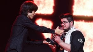 Masahiro Sakurai giving trophy to Invitational winner Gonzalo "ZeRo" Barrios