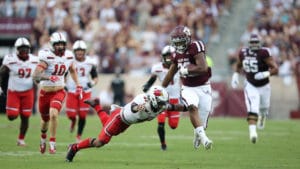 Isaiah Spiller breaking a tackle